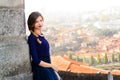 Young elegant woman in blue long flying dress posing at stairway against old city building Royalty Free Stock Photo