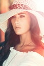 Young elegant woman outdoor portrait with hat summer day