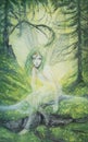 Young elf fairy with green hair and dragonfly wings in a green forest Royalty Free Stock Photo