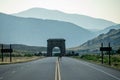 Young Elk Crosses The Empty Road Near Roosevelt Arch Royalty Free Stock Photo