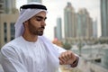 Young Emirati arab man standing by the canal