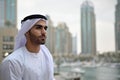 Young Emirati arab man standing by the canal