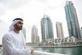 Young Emirati arab man standing by the canal