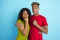 Young emotional african-american man and woman on blue background