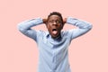 The young emotional angry man screaming on pink studio background Royalty Free Stock Photo