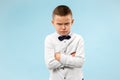 The young emotional angry teen boy on blue studio background Royalty Free Stock Photo