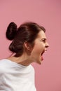 The young emotional angry woman screaming on pink studio background Royalty Free Stock Photo