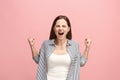 The young emotional angry woman screaming on pink studio background Royalty Free Stock Photo