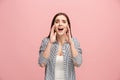 The young emotional angry woman screaming on pink studio background Royalty Free Stock Photo