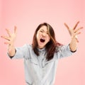 The young emotional angry woman screaming on pink studio background Royalty Free Stock Photo