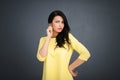 Young emotional beauty woman standing on gray background Royalty Free Stock Photo