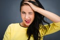 Young emotional beauty woman standing on gray background Royalty Free Stock Photo