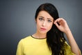 Young emotional beauty woman standing on gray background Royalty Free Stock Photo