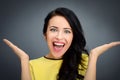 Young emotional beauty woman standing on gray background Royalty Free Stock Photo