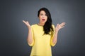 Young emotional beauty woman standing on gray background Royalty Free Stock Photo