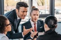 Young emotional businesspeople in formalwear arguing at meeting in office Royalty Free Stock Photo