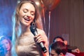 Emotional female singer in karaoke bar Royalty Free Stock Photo