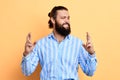 Young emotional man making a wish isolated on yellow background Royalty Free Stock Photo