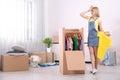 Young emotional woman near wardrobe box