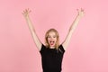 Young emotional woman on pink studio background. Human emotions, facial expression concept.