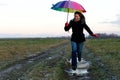 Young emotional woman with an umbrella on a walk, nature light Royalty Free Stock Photo