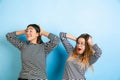 Young emotional women on gradient blue background Royalty Free Stock Photo