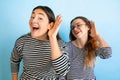 Young emotional women on gradient blue background