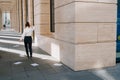 The young employee girl quit her job and goes to the evil home. Full-length view of the rear near the business center. Dismissal Royalty Free Stock Photo