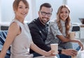 Young employee with her colleagues sitting in the office lobby Royalty Free Stock Photo