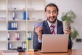 Young male employee playing cards at workplace Royalty Free Stock Photo