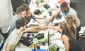 Young employee startup workers group stacking hands at urban stu