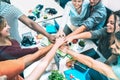 Young employee startup workers stacking hands at urban studio workspace on entrepreneurship brainstorming project Royalty Free Stock Photo