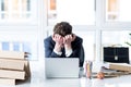 Young employee is tired of working on laptop Royalty Free Stock Photo