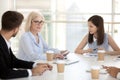 Young employees listen to female boss talking during briefing