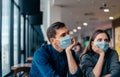 young employees in protective masks sitting at the office Desk. Royalty Free Stock Photo