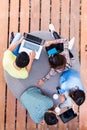 Young employees using modern wireless technology while working