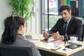 Young employers in black suits are evaluating job applicants by asking marketing strategy questions