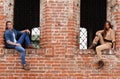 Young enamoured pair a brick wall