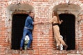 Young enamoured pair a brick wall