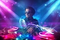 Energetic Dj mixing music with powerful light effects