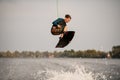 young energetic wakeboarder jumping high over river water Royalty Free Stock Photo