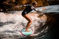 Young energetic woman go in for active water sport with surf style wakeboard