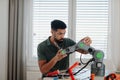 Young engineer building and programming a robotic arm at home. Royalty Free Stock Photo