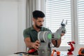 Young engineer building and programming a robotic arm at home. Royalty Free Stock Photo