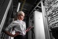 Young engineer businesswoman in network server room Royalty Free Stock Photo