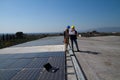 Young engineer girl and skilled worker on a roof Royalty Free Stock Photo