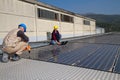 Young engineer girl and skilled worker on a roof Royalty Free Stock Photo