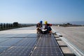 Young engineer girl and skilled worker on a roof Royalty Free Stock Photo