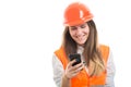 Young engineer girl reading messages on smartphone Royalty Free Stock Photo