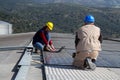 Young engineer girl and skilled worker on a roof Royalty Free Stock Photo